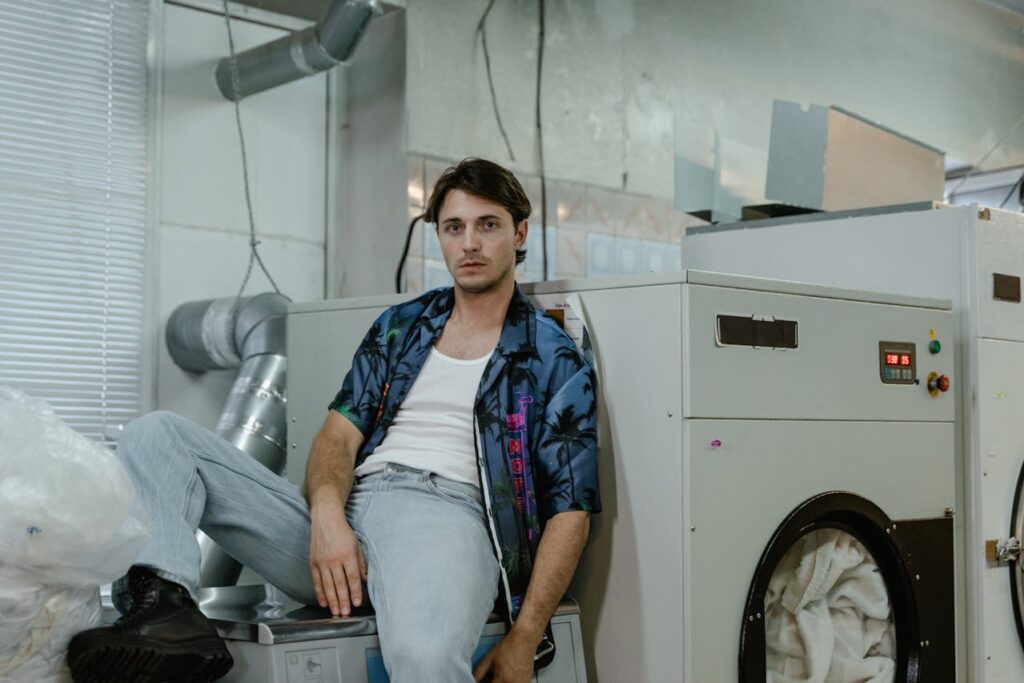 man-sitting-in-laundry-room