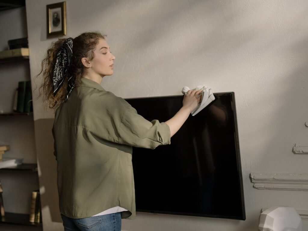 woman-wiping-television